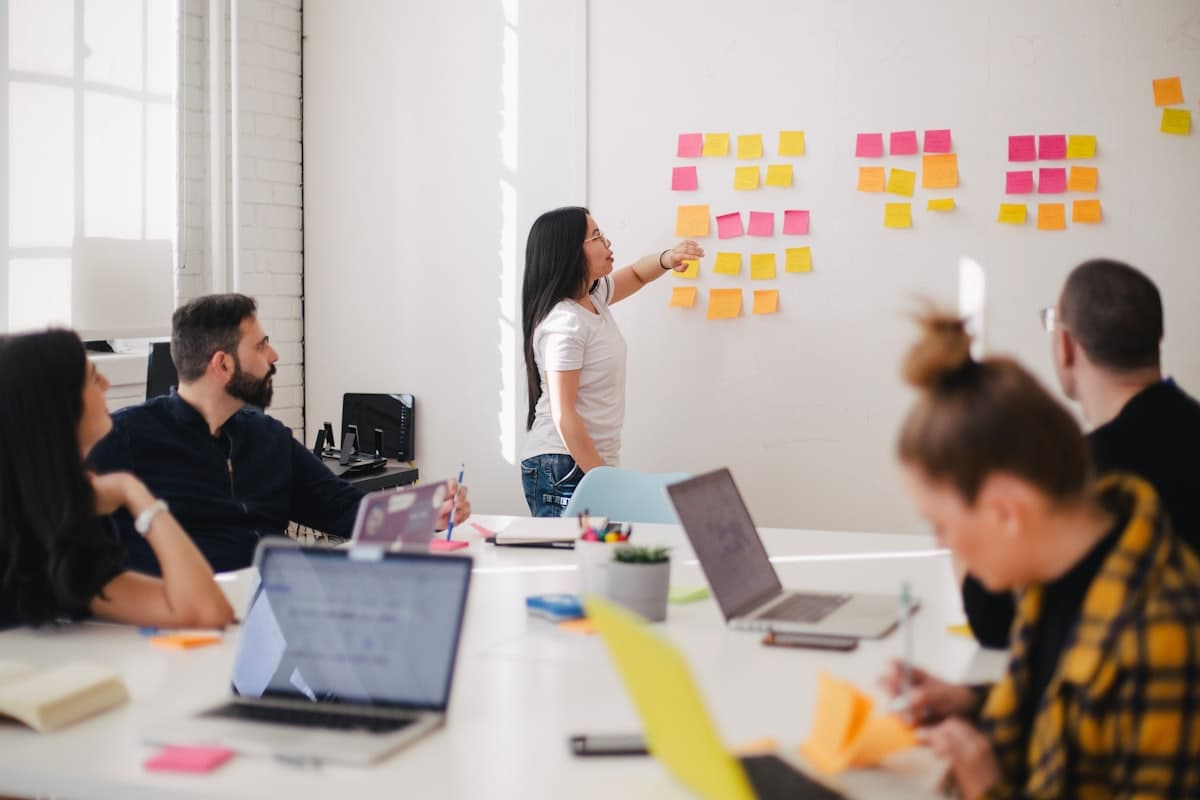 A product team running a planning workshop around a wall of sticky notes