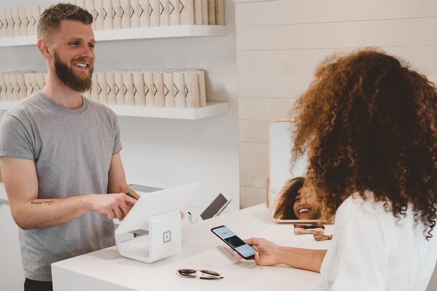A shop assistant taking a contactless card payment